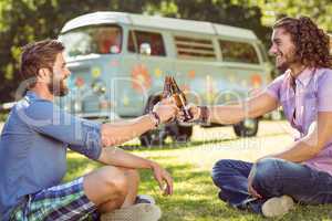 Hipster friends toasting with beers