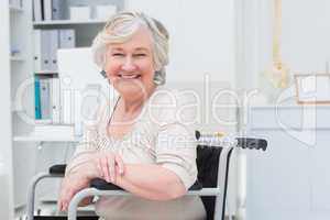 Happy senior woman sitting on wheelchair