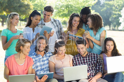 Smiling friends using media devices