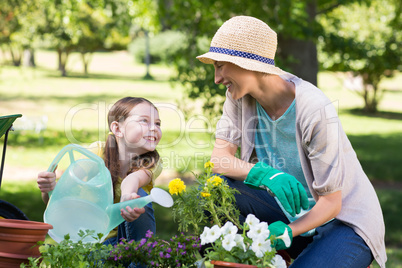 Happy blonde and her daughter gardening