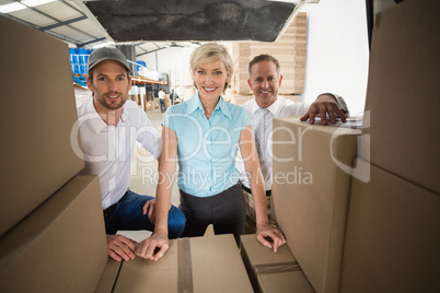 Portrait of managers smiling at camera behind the van