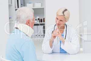 Doctor looking at senior patient wearing neck brace
