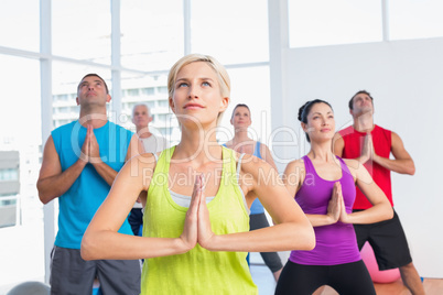 People meditating in fitness club