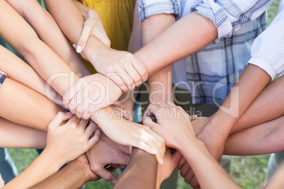 Friends putting their hands together