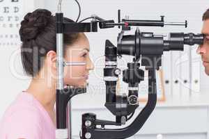 Female patient being examined by optician