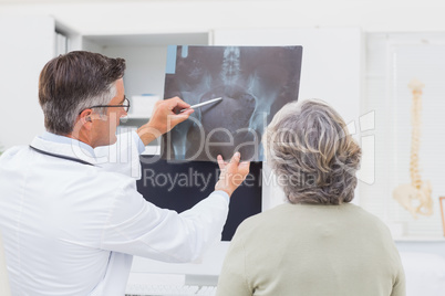 Doctor explaining x-ray to female patient