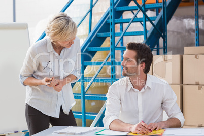 Warehouse managers speaking during a meeting