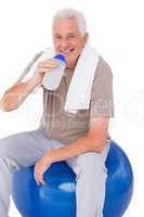 Senior man drinking from water bottle