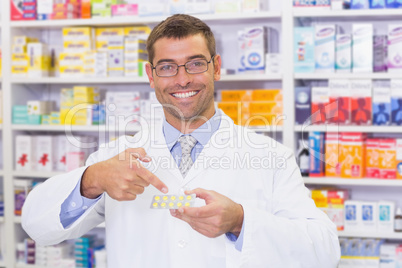 Pharmacist pointing blister packs