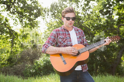 Handsome hipster playing the guitar