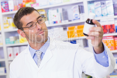 Pharmacist holding medicine jar