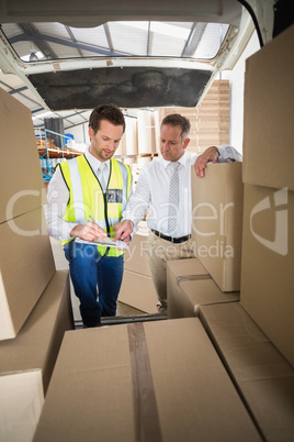 Delivery driver checking his list on clipboard