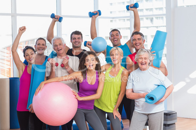 Excited people holding exercise equipment