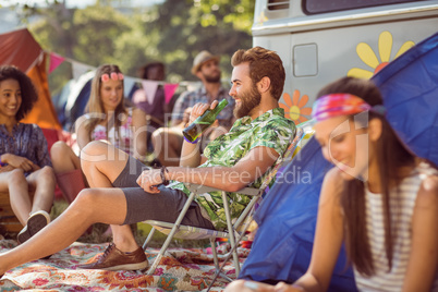 Carefree hipster relaxing on campsite