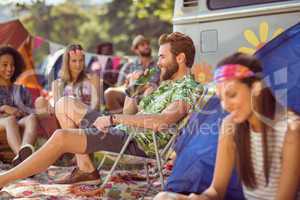 Carefree hipster relaxing on campsite