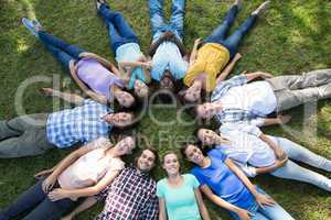 Happy friends in the park lying in circle