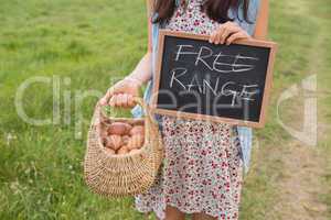 Woman holding basket of free range eggs