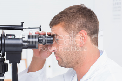 Optician using slit lamp in clinic