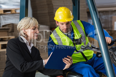 Forklift driver talking with his manager