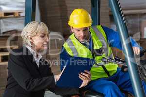 Forklift driver talking with his manager