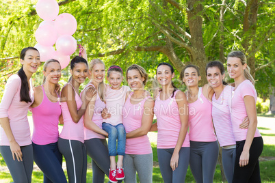 Smiling women in pink for breast cancer awareness