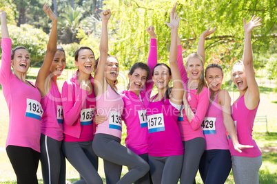 Smiling women running for breast cancer awareness