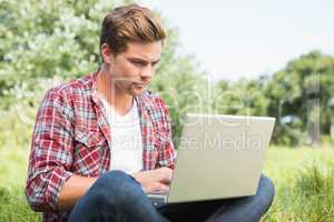 Man with laptop in park