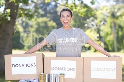 Pretty volunteer with donation boxes in park