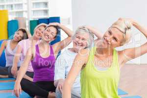 Women doing neck exercise at fitness club