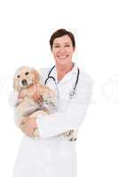 Smiling veterinarian with a cute dog in her arms