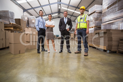 Warehouse team standing looking at camera