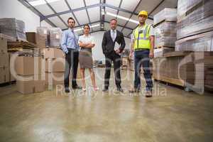 Warehouse team standing looking at camera