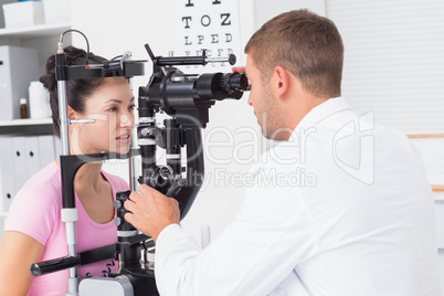 Female patient being examined by optician in clinic