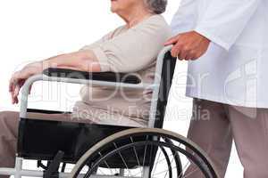 Doctor pushing patient in wheelchair