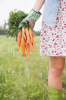 Woman holding her organic carrots