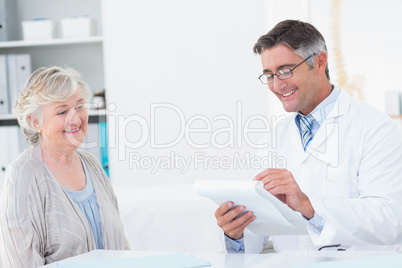 Doctor writing prescriptions for senior patient