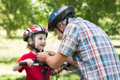 Father attaching his sons cycling helmet