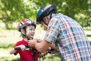 Father attaching his sons cycling helmet