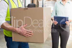 Close up of a warehouse worker carrying box