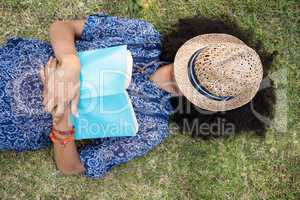 Pretty young woman napping in park