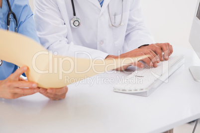 Doctors using computer looking at files