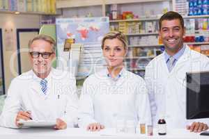 Team of pharmacists smiling at camera