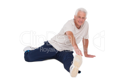 Senior man stretching his leg