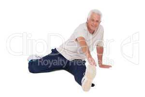 Senior man stretching his leg