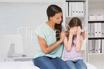 Little girl crying with her mother