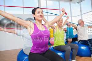 People exercising with resistance bands in gym