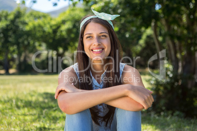 Pretty brunette relaxing in the park