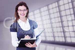 Composite image of happy woman writing in diary