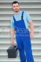 Composite image of repairman with toolbox