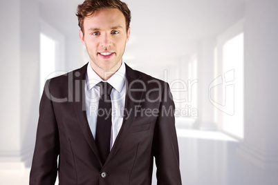 Composite image of young businessman smiling at camera